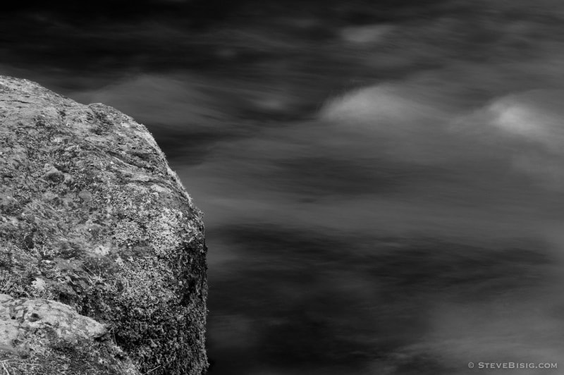 A black and white, long exposure photograph of the Lyre River on the Olympic Peninsula in Washington State