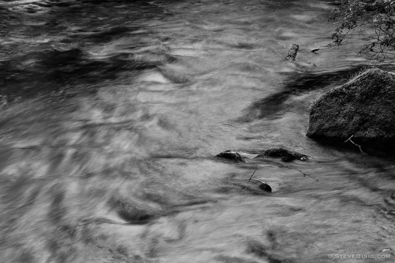 A black and white, long exposure photograph of the Lyre River on the Olympic Peninsula in Washington State.