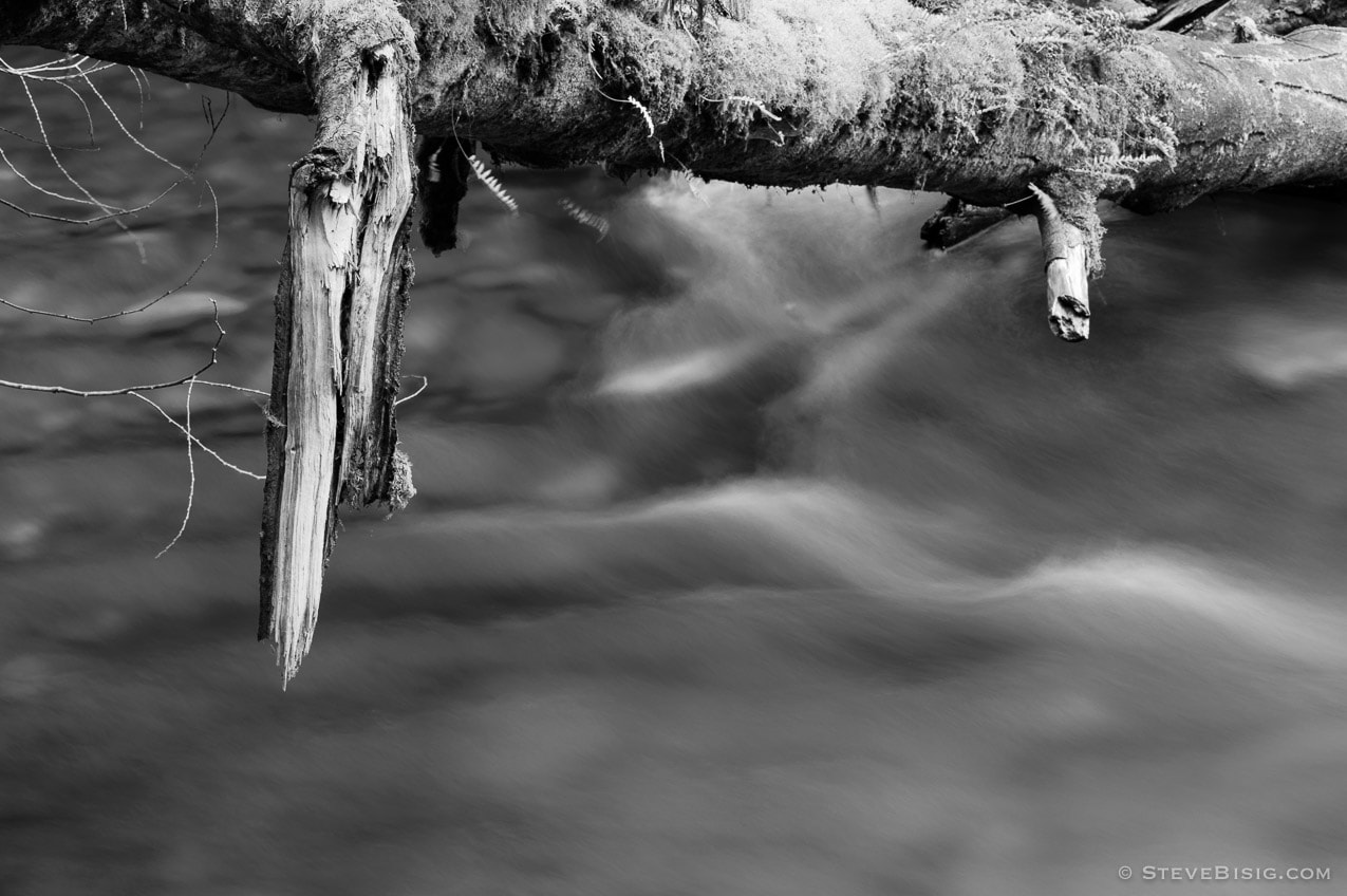 A black and white, long exposure photograph of the Lyre River on the Olympic Peninsula in Washington State.