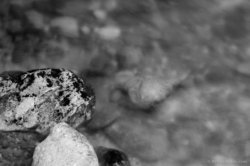 A black and white, long exposure photograph of the Lyre River on the Olympic Peninsula in Washington State.