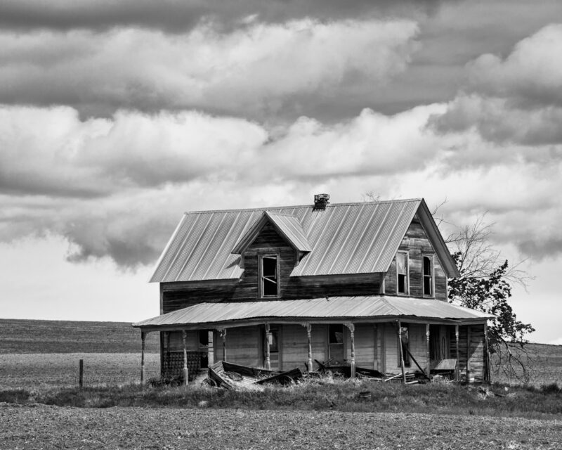 A black and white photograph of an old farmhouse in rural Douglas County, Washington.