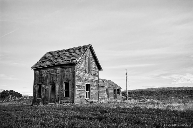 A black and white photograph of an old farmhouse in rural Douglas County, Washington.