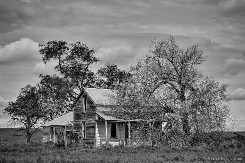 A black and white photograph of an old farm in rural Douglas County, Washington.