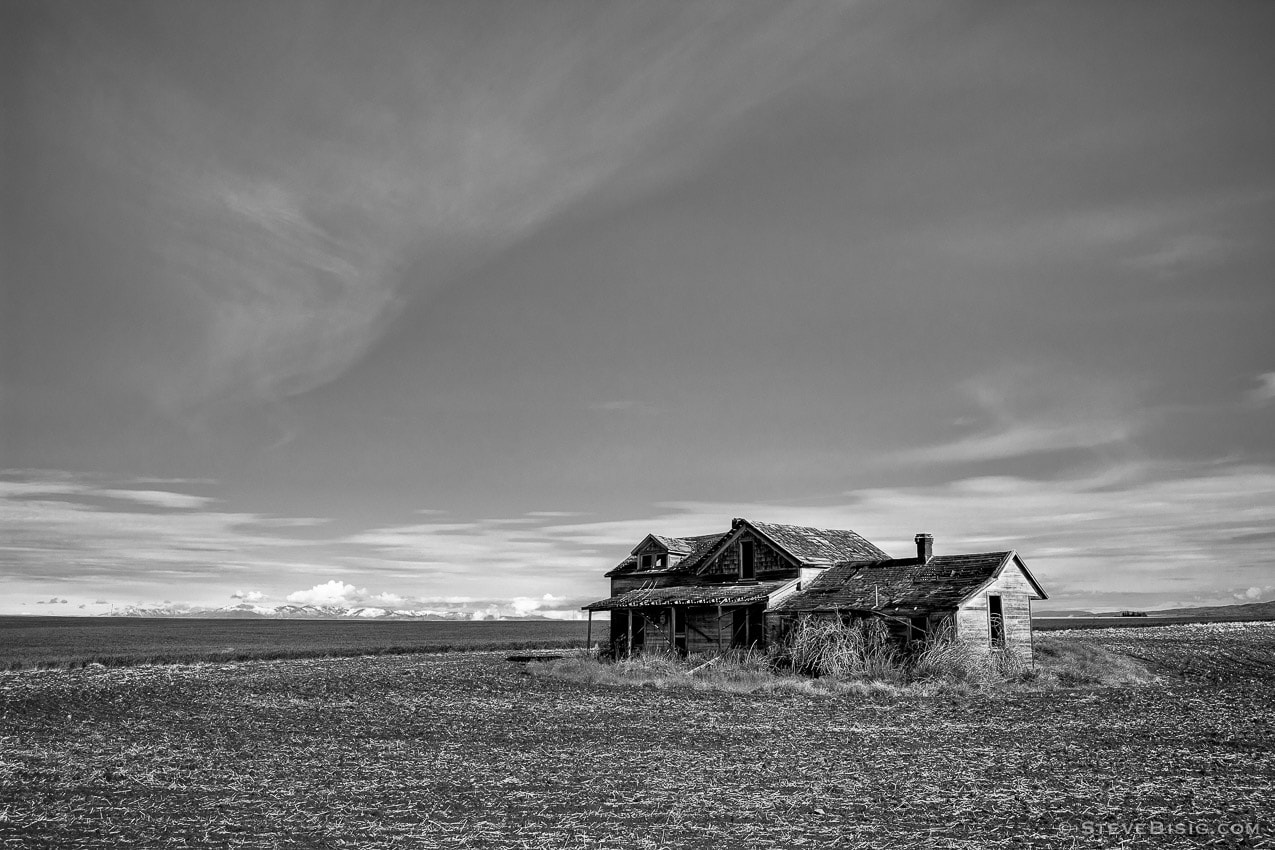 A black and white photograph of old abandoned farm house in rural Douglas County near Withrow, Washington.