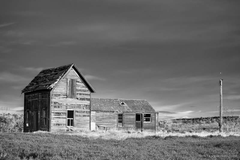 A black and white photograph of an old farmhouse in rural Douglas County, Washington.