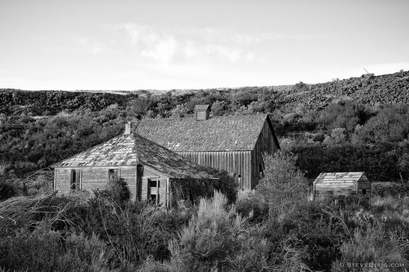 A black and white photograph of an old house and barn in Alstown, Washington.