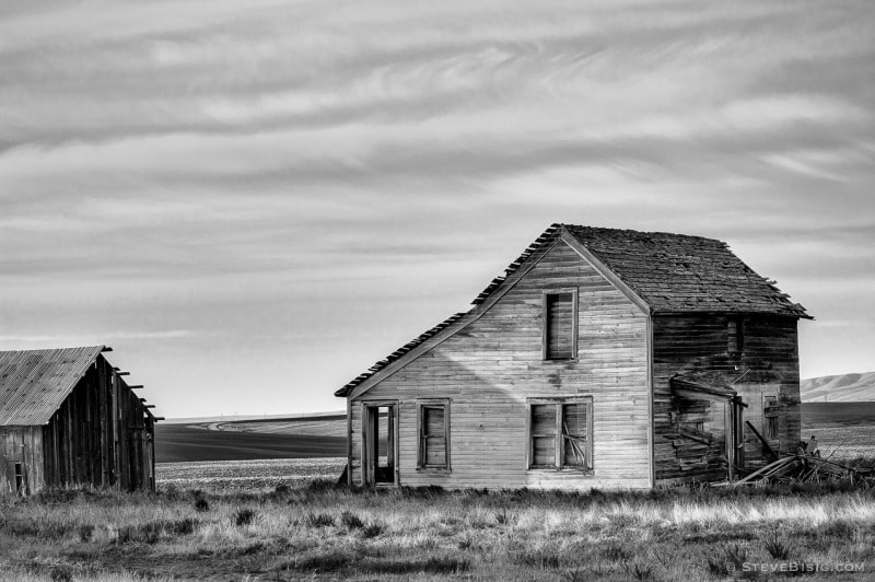 A black and white photograph of an old farmhouse in rural Douglas County, Washington.