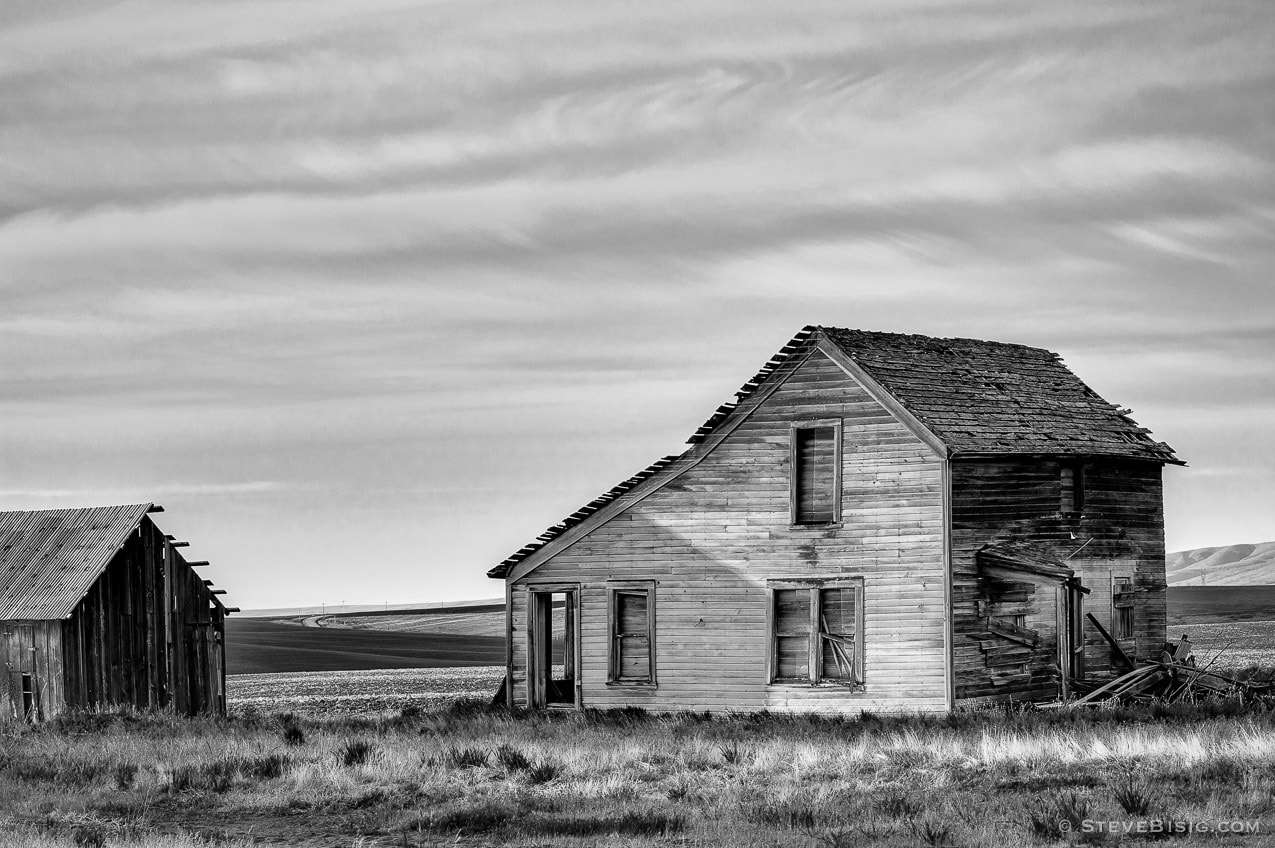 A black and white photograph of old abandoned house on Q Road NW in rural Douglas County, Washington.