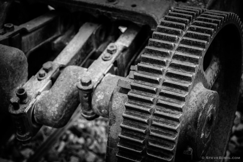 A black and white photograph of old rusty coal mining equipment in Roslyn, Washington.