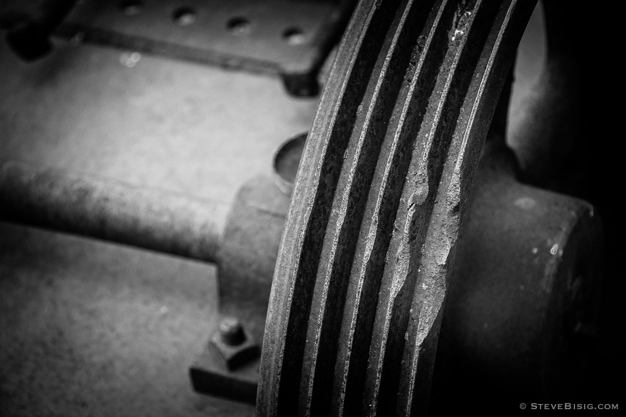 A black and white photograph of old rusty coal mining equipment in Roslyn, Washington.