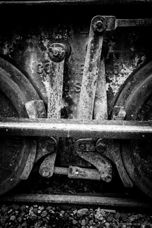 A black and white photograph of old rusty coal mining equipment in Black Diamond, Washington.