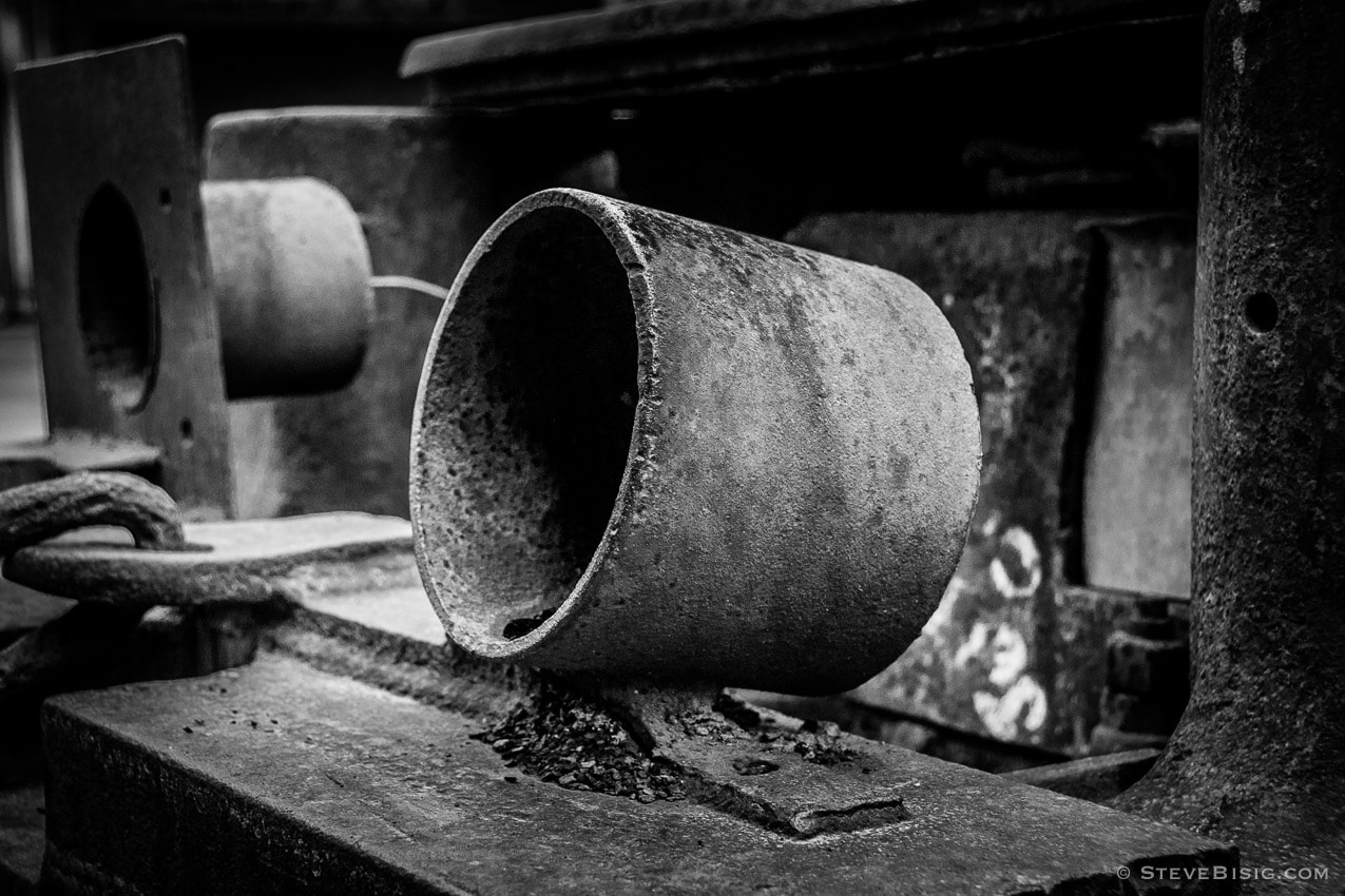 A black and white photograph of old rusty coal mining equipment in Black Diamond, Washington.