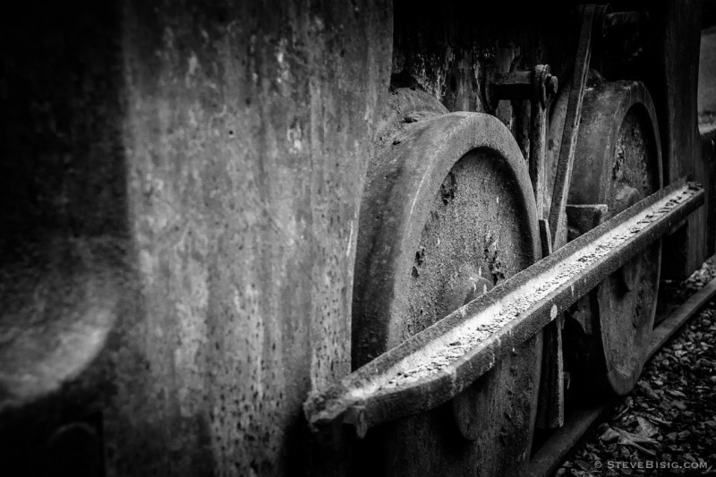 A black and white photograph of old rusty coal mining equipment in Black Diamond, Washington.