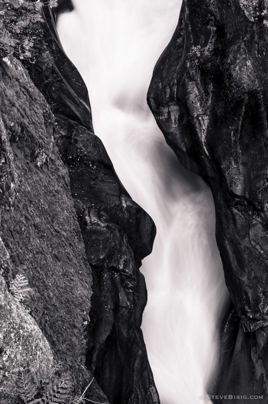 A black and white photograph of the Muddy Fork of the Cowlitz River as it passes through Box Canyon at Mount Rainier National Park, Washington.