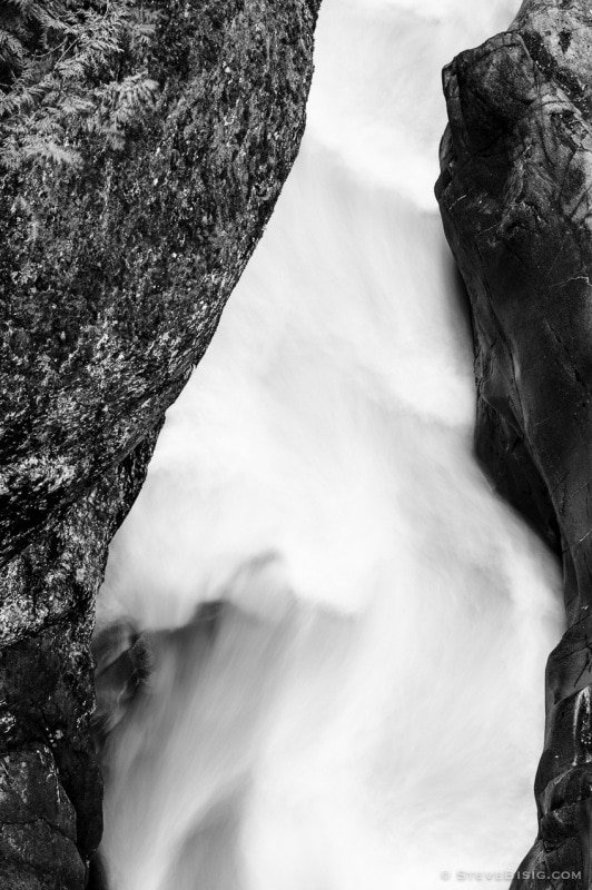 A black and white photograph of the Muddy Fork of the Cowlitz River as it passes through Box Canyon at Mount Rainier National Park, Washington.