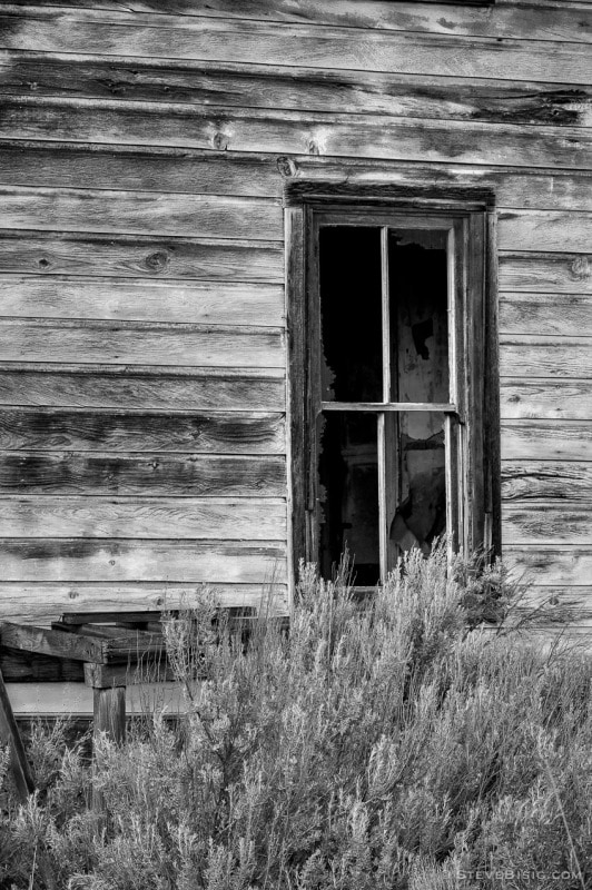 A black and white photograph of a window from an old house in Alstown, Washington.