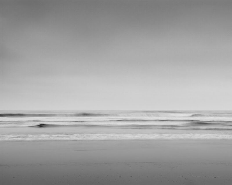 This mesmerizing black and white photograph captures the serene beauty of Kalaloch Beach along the Olympic Peninsula, Washington. The long exposure technique imbues the Pacific Ocean waves with a mystical, ethereal quality, blurring motion and time. The minimalist landscape, where the sea meets the sky, invites viewers into a world of peaceful reflection and timeless beauty.