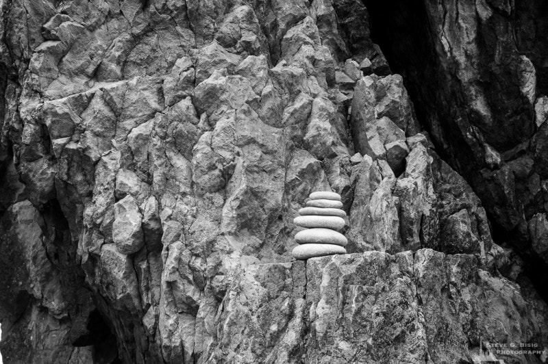 A photograph of a cairn sitting on a rock ledge at Ruby Beach in the Olympic National Park in Washington State.