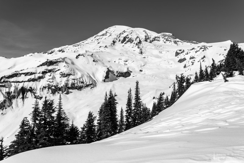 A black and white landscape photograph of Mount Rainier during Winter near the Paradise Visitors Center at Mount Rainier National Park, Washington.