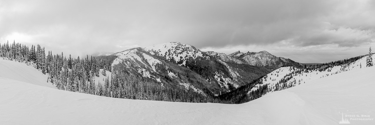 A black and white panoramic photograph of Griff Peak, Hurricane Hill and the Little River drainage as seen from Hurricane Ridge on a Winter day in the Olympic National Park, Washington.