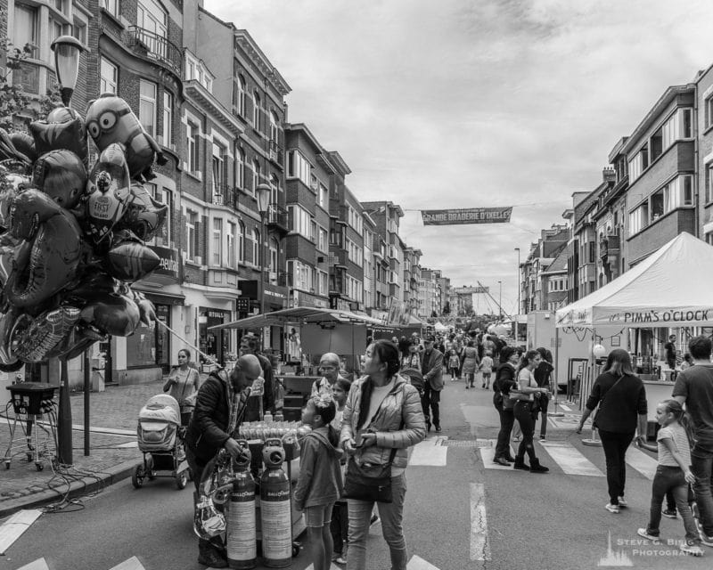 One of a series of black and white photographs from the 2018 Grande Braderie D'Ixelles sidewalk sale and street festival in Brussels, Belgium.