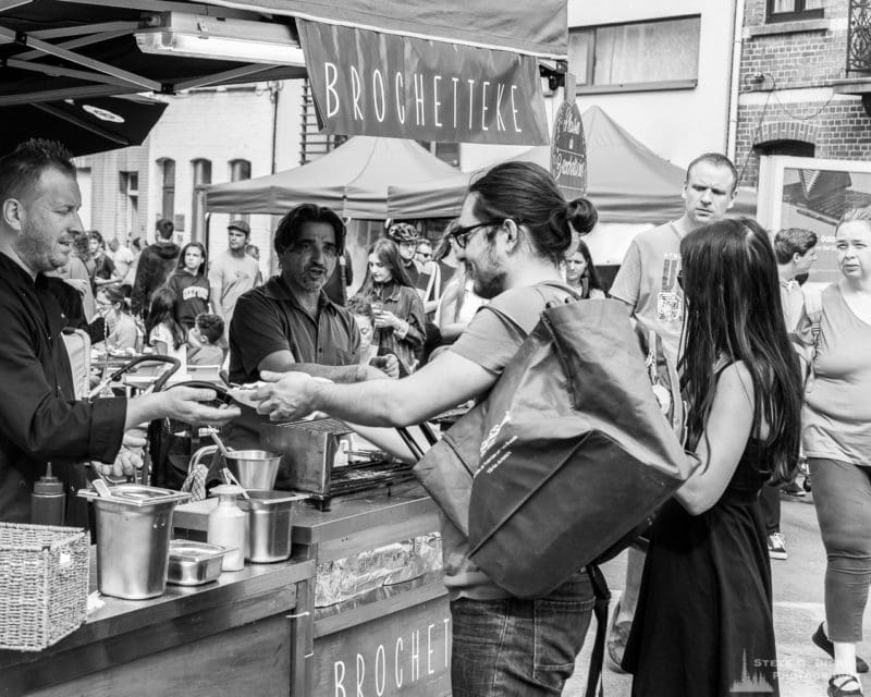 One of a series of black and white photographs from the 2018 Grande Braderie D'Ixelles sidewalk sale and street festival in Brussels, Belgium.