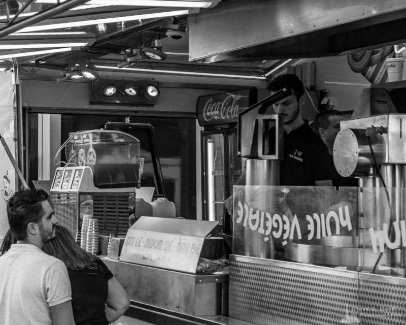 One of a series of black and white photographs from the 2018 Grande Braderie D'Ixelles sidewalk sale and street festival in Brussels, Belgium.