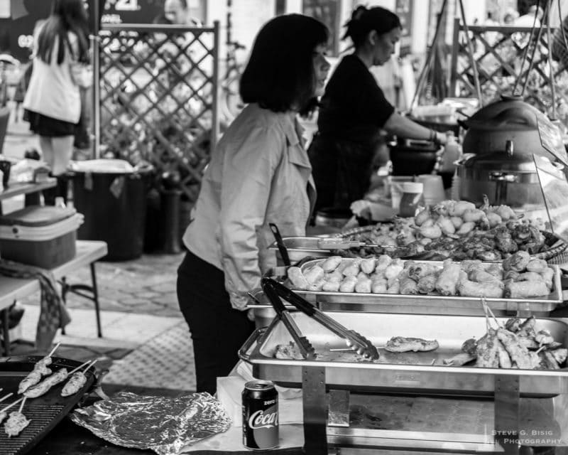 One of a series of black and white photographs from the 2018 Grande Braderie D'Ixelles sidewalk sale and street festival in Brussels, Belgium.