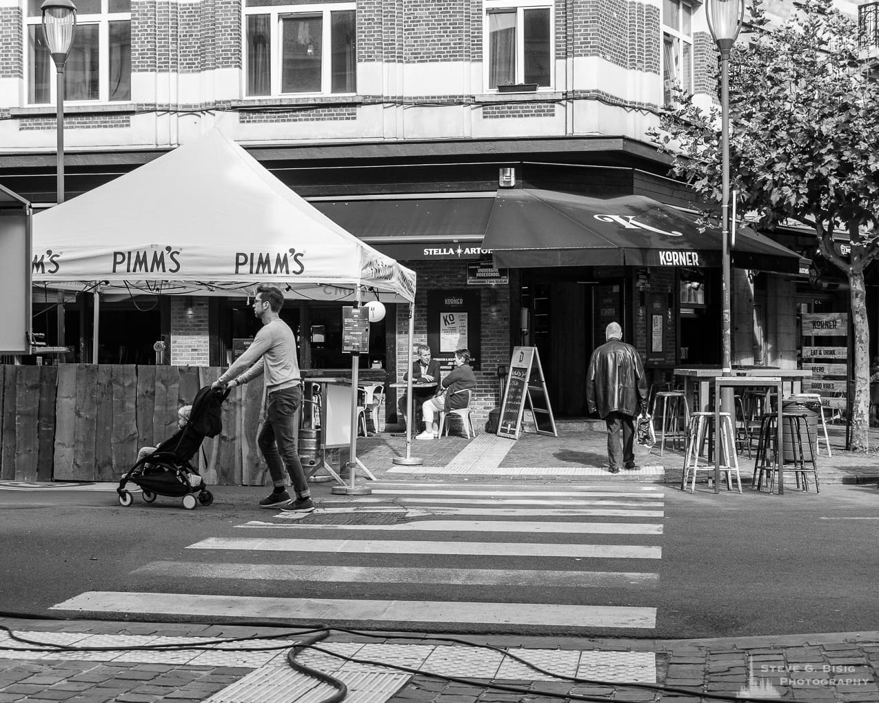 One of a series of black and white photographs from the 2018 Grande Braderie D'Ixelles sidewalk sale and street festival in Brussels, Belgium.