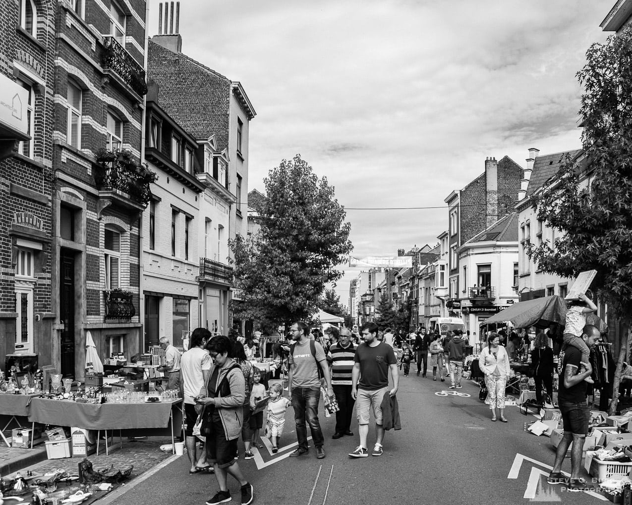 One of a series of black and white photographs from the 2018 Grande Braderie D'Ixelles sidewalk sale and street festival in Brussels, Belgium.