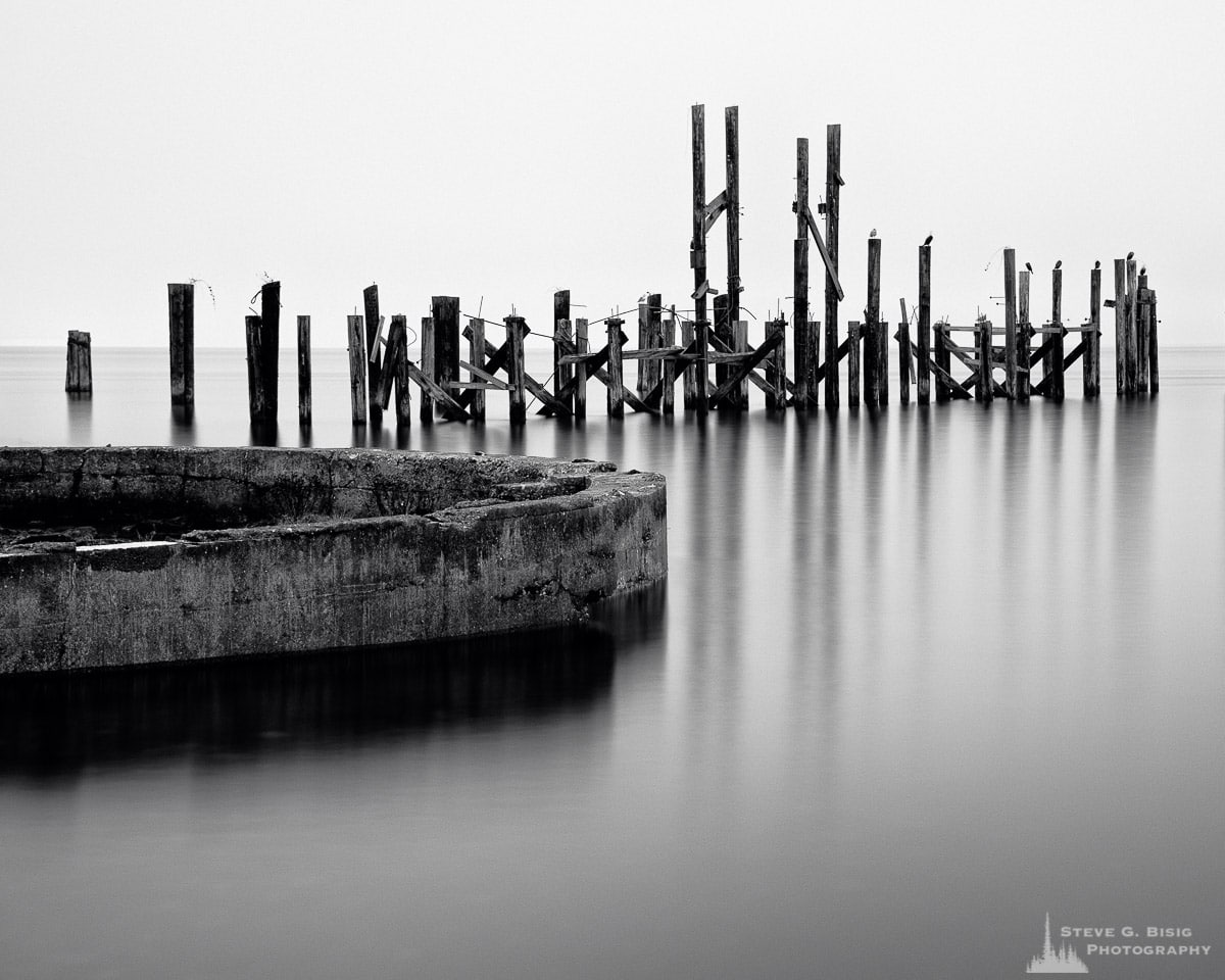 A black and white photograph of old ruins from the Dickman Mill on the Puget Sound along Ruston Way, Tacoma, Washington.