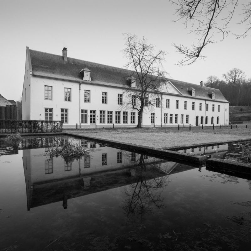 A black and white photograph of the Prior's House from the Abbaye du Rouge Cloître in Auderghem, Belgium.