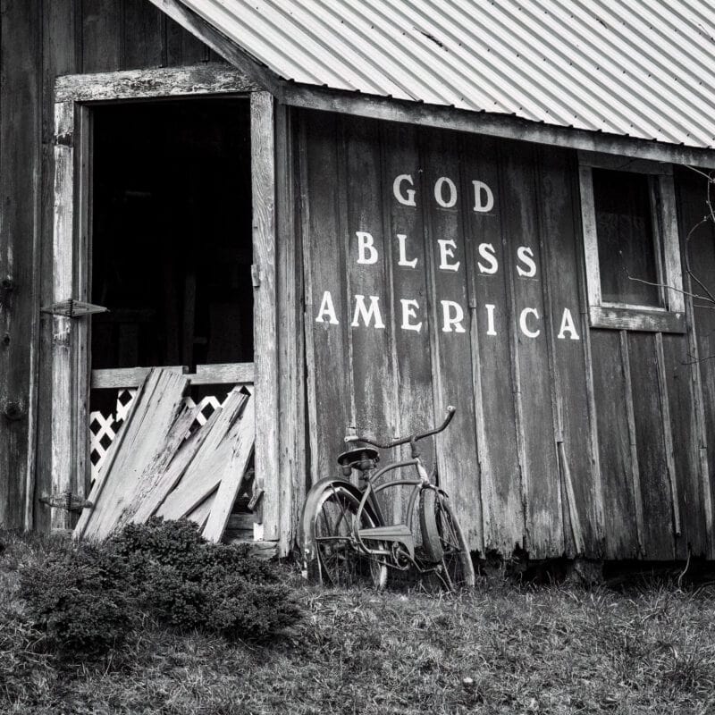 A close-up black and white photograph of an old barn and bicycle in rural Grays Harbor County, Washington.