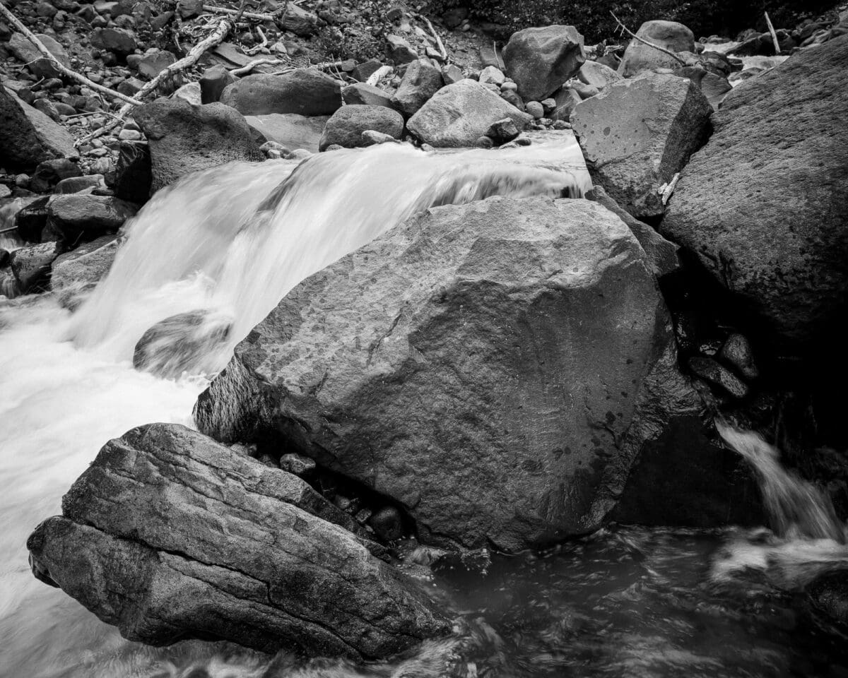 Escape into the tranquility of nature with this stunning landscape photograph capturing the serene beauty of a mountain stream in Mt Rainier National Park. The interplay of light and shadow creates a peaceful ambiance that will soothe your senses and invigorate your soul. Perfect for your home or workspace, this photo will transport you to a place of calmness and relaxation every time you glance at it.