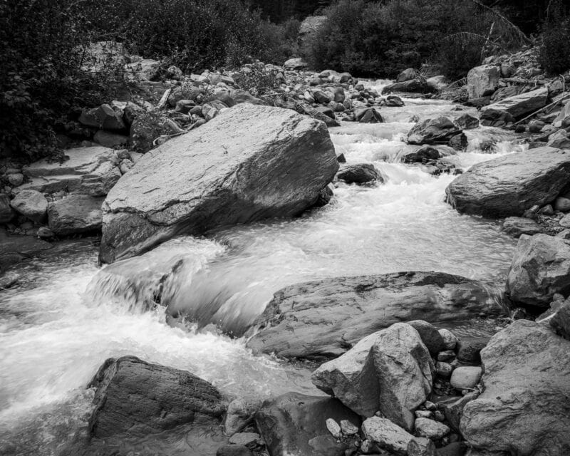 Indulge in the peaceful allure of nature showcased in a breathtaking interplay of illumination and shade. This intimate landscape photograph of a mountain stream in Mt Rainier National Park exudes calmness, making it a perfect adornment for your living or workspace.