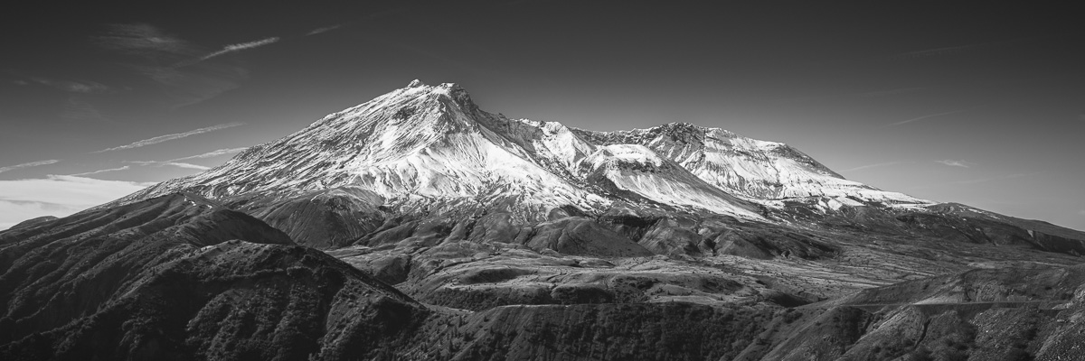 The first snowfall of Autumn blankets Mt. St. Helens in quiet elegance, captured here in this panoramic black and white image. The snow’s delicate layer brings a peaceful contrast to the volcanic landscape. It’s a reminder of nature’s power to transform and renew.