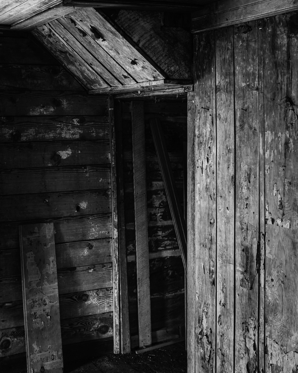 Step into a world where shadows dance among the remnants of a forgotten space. This black-and-white photograph invites you to explore themes of history and solitude within the Whitcomb-Cole Log House in Washington. The interplay of light and darkness adds depth, turning a simple scene into a whispering testament of time. Perfect for those looking to add a thought-provoking piece to their collection.