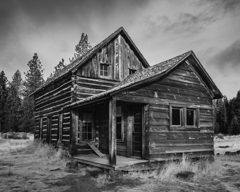 This black-and-white photograph of the Whitcomb-Cole Hewn Log House in Glenwood Valley, Washington, evokes a sense of nostalgia and tranquility. The rustic character of this historic cabin reflects stories of resilience and the passage of time, inviting contemplation on the lives once filled with warmth and laughter. A perfect addition to any thoughtful space, this piece resonates with those captivated by the beauty of forgotten moments.