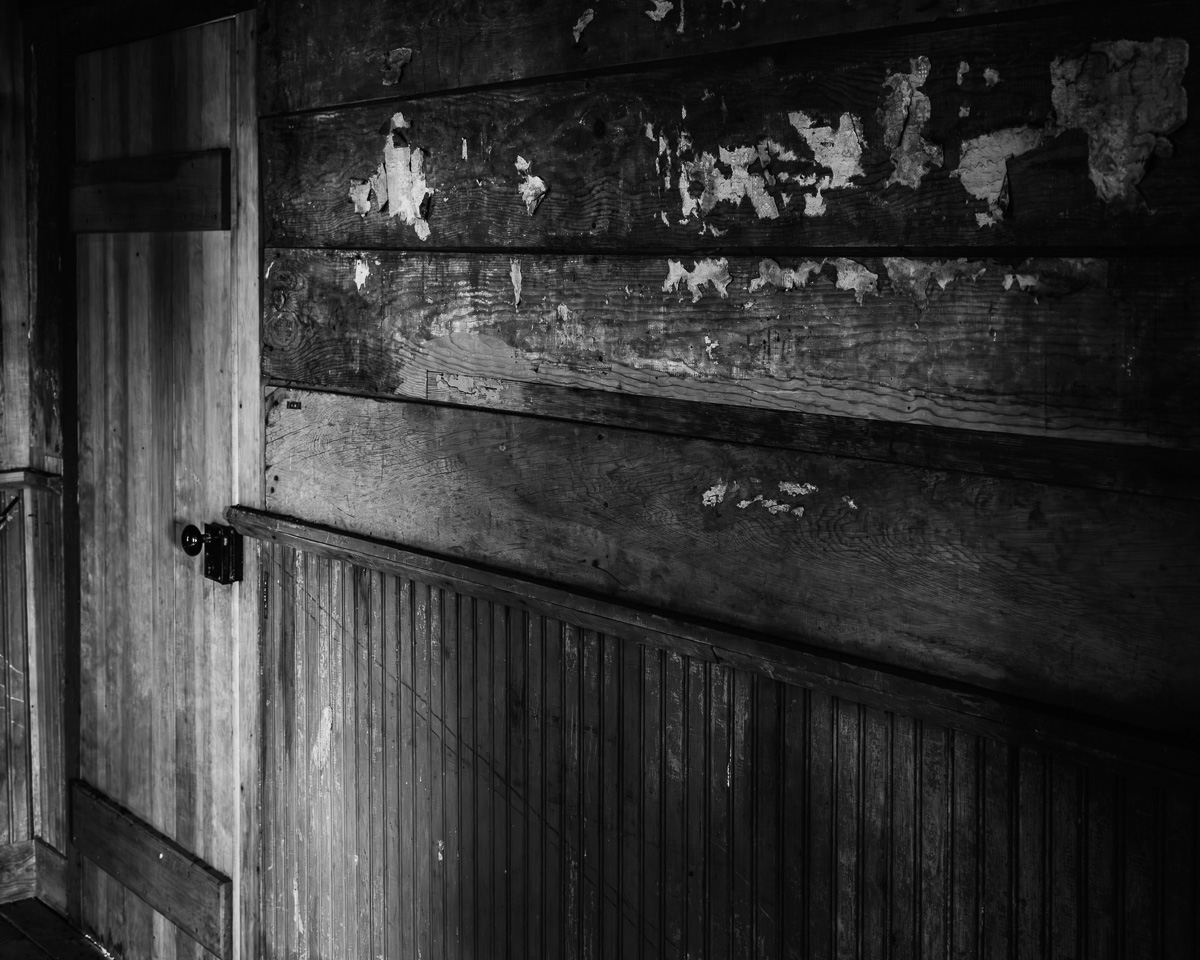 Step into the whispers of history with this black-and-white photograph. It reveals the worn textures and muted tones of the Whitcomb-Cole Log House, a testament to the resilience and craftsmanship of early settlers. The interplay of light and shadow conjures a sense of tranquility, making it a perfect piece for anyone wanting to add a touch of rustic charm to their home or gallery.