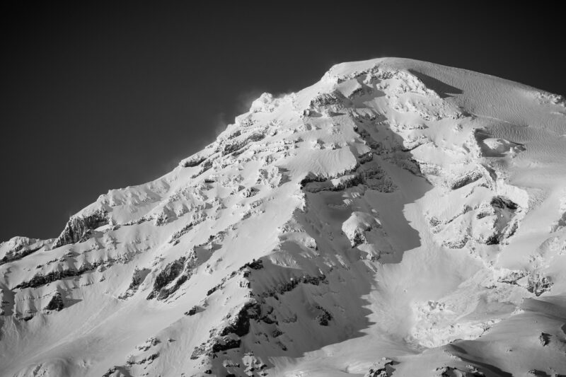 A closeup landscape photograph of the southwest corner face of a snow covered Mount Rainier on an early winter evening, captured along the Paradise Road at Mount Rainier National Park, Washington.