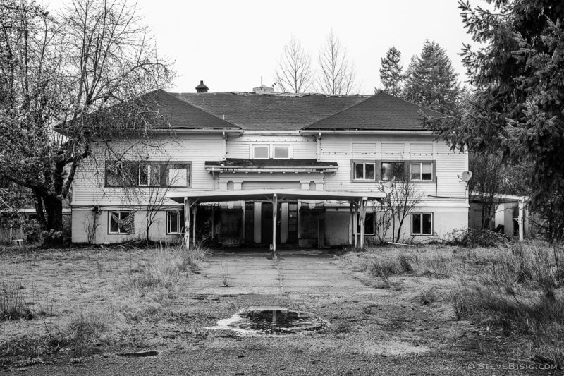 A black and white photograph of an abandoned schoolhouse in the rural Lewis County community of Dryad, Washington.