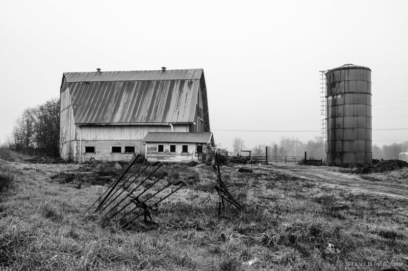 A black and white photograph of a barn and silo on a farm along State Route 6 in rural Lewis County near Adna, Washington.