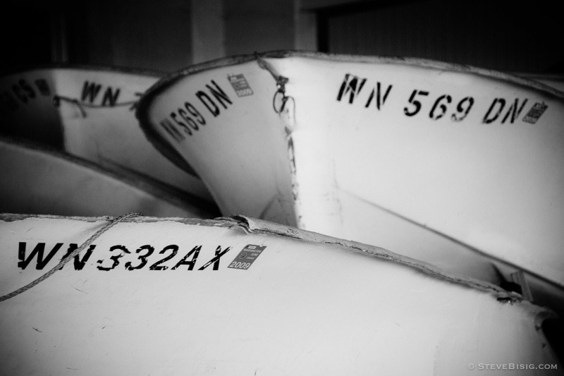 A black and white photograph of rental boats at the Point Defiance Marina, Tacoma, Washington.