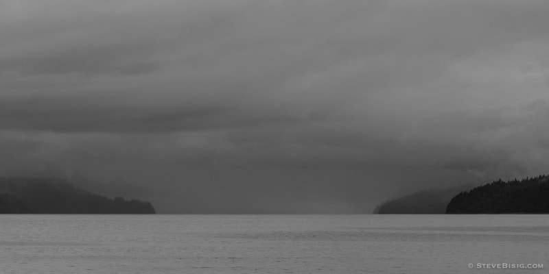 A black and white photograph of Hood Canal, Washington on a cloudy Summer day.