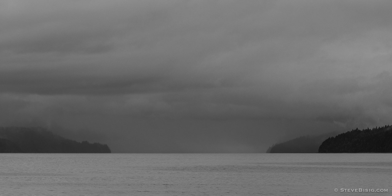 A black and white photograph of Hood Canal, Washington on a cloudy Summer day.