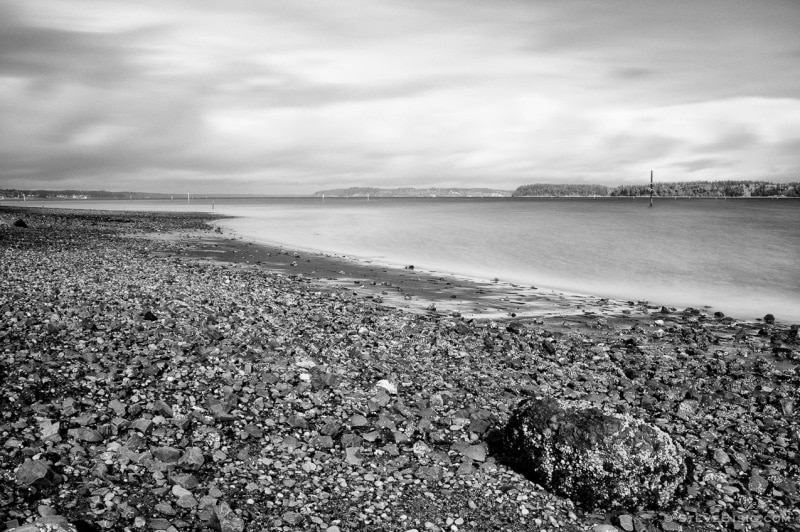 A black and white, long exposure photograph of Hogum Bay at low tide on the Puget Sound. Thurston County, Washington.