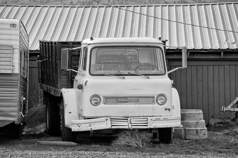 A black and white photograph of an old International Harvester Cabover farm truck along Weaver Road in Kittitas County near Ellensburg, Washington.