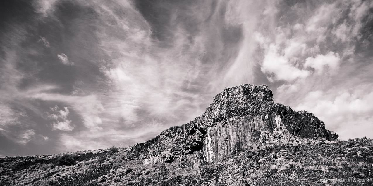 A black and white fine art landscape photograph of rock formations along the Slack Canyon Road in Grant County, Washington.