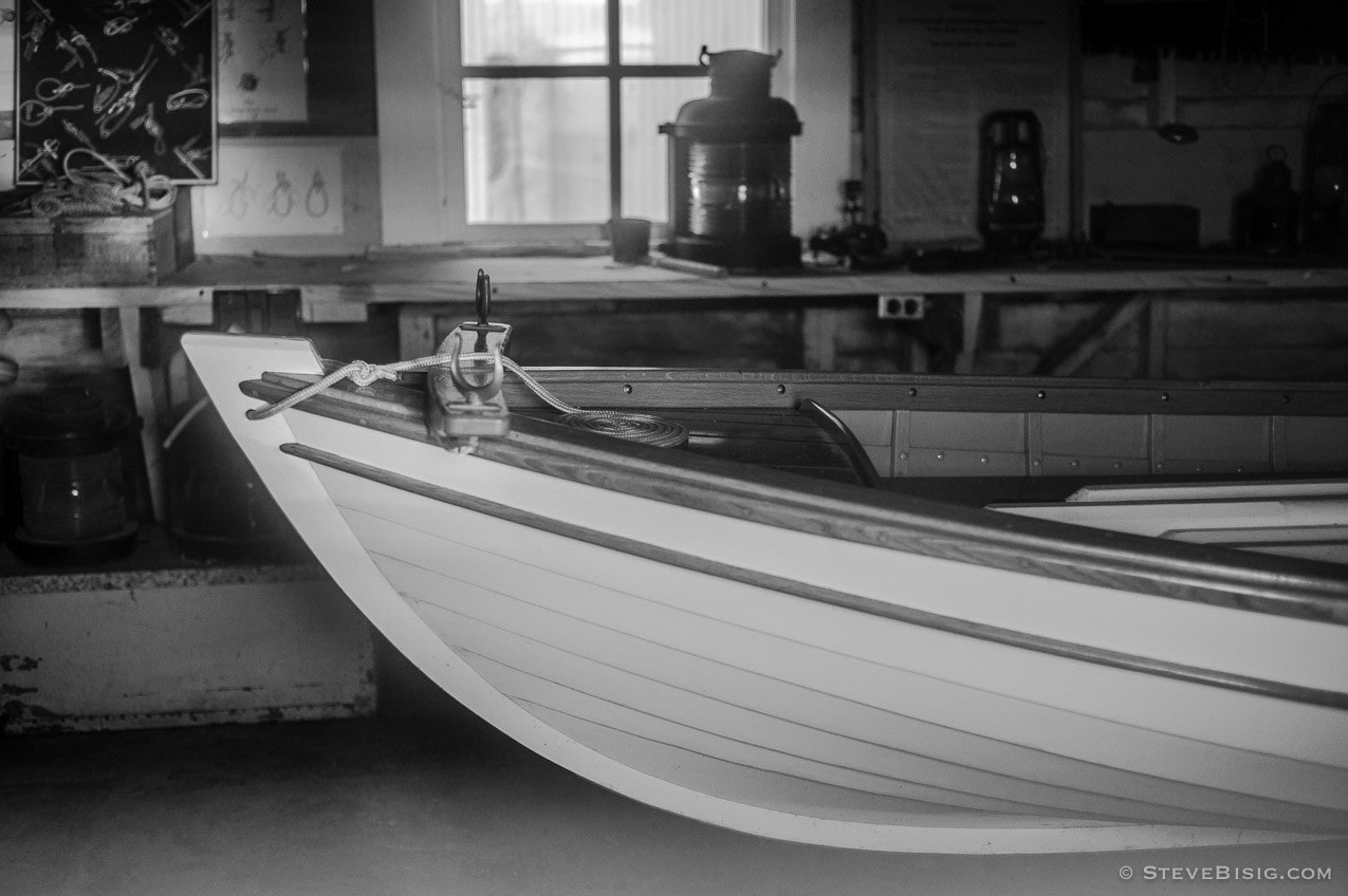 A black and white photograph looking through the window of the historic boat house at Browns Point, Washington.