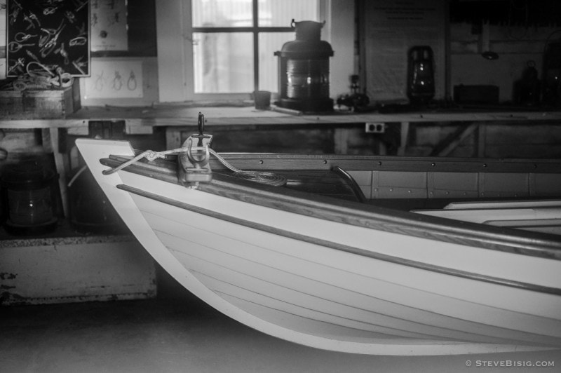 A black and white photograph looking through the window of the historic boat house at Browns Point, Washington.